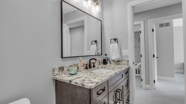 half bathroom featuring vanity and baseboards