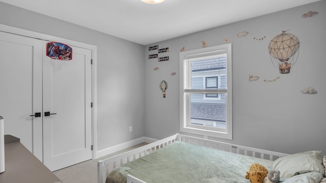 bedroom with baseboards and a closet