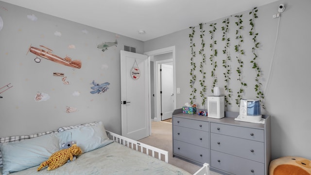 bedroom featuring light carpet and baseboards