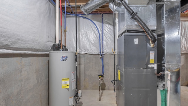 utility room featuring water heater and heating unit