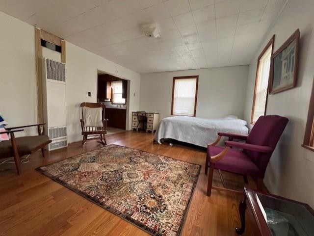 205 Evans St, East Tawas, MI 48730 - bedroom featuring a heating unit and wood finished floors