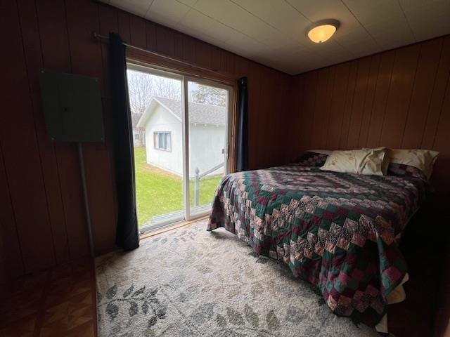 205 Evans St, East Tawas, MI 48730 - bedroom featuring access to exterior and wooden walls