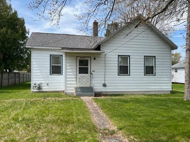 205 Evans St, East Tawas, MI 48730 - back of house with a chimney and roof with shingles