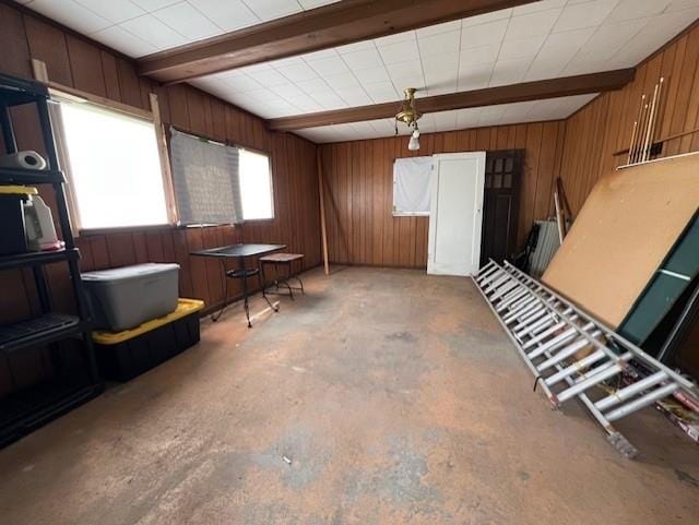 205 Evans St, East Tawas, MI 48730 - miscellaneous room featuring wooden walls, concrete floors, and beam ceiling
