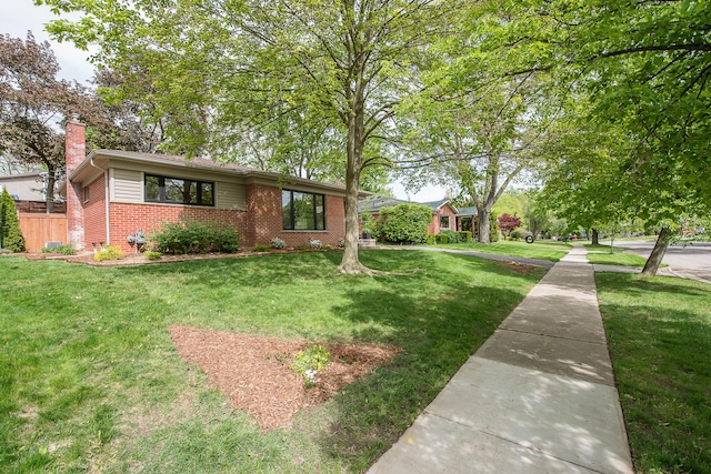 2441 Nottingham Rd, Ann Arbor, MI 48104 - view of front of property featuring brick siding, a chimney, and a front yard