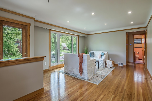 2441 Nottingham Rd, Ann Arbor, MI 48104 - living room featuring ornamental molding, plenty of natural light, wood finished floors, recessed lighting, and baseboards