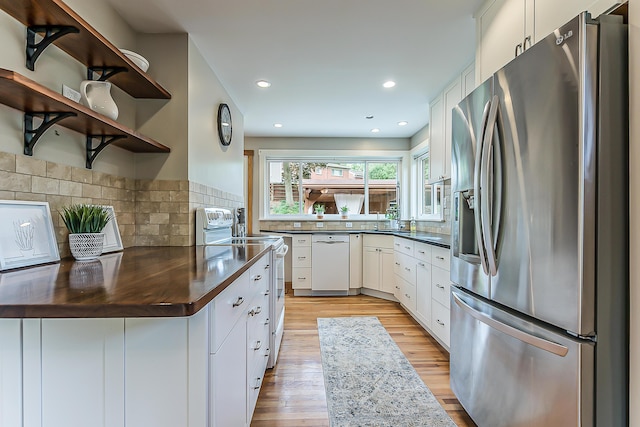 2441 Nottingham Rd, Ann Arbor, MI 48104 - kitchen featuring white appliances, open shelves, dark countertops, light wood-style floors, and recessed lighting