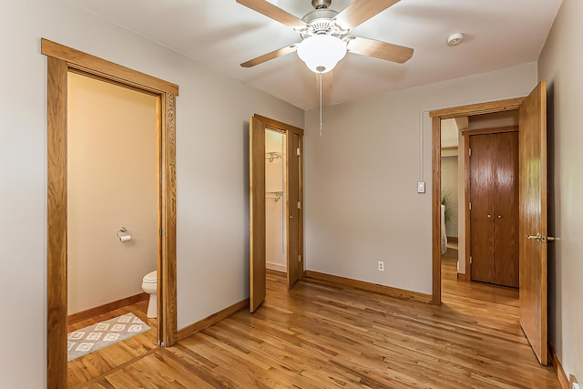 2441 Nottingham Rd, Ann Arbor, MI 48104 - unfurnished bedroom with light wood finished floors, baseboards, connected bathroom, and ceiling fan