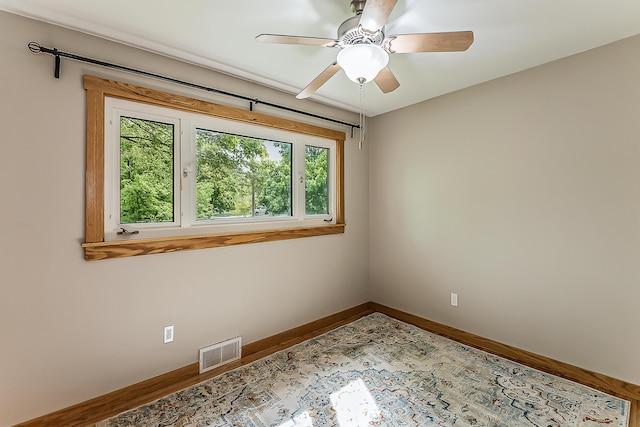 2441 Nottingham Rd, Ann Arbor, MI 48104 - unfurnished room with baseboards, wood finished floors, and ceiling fan