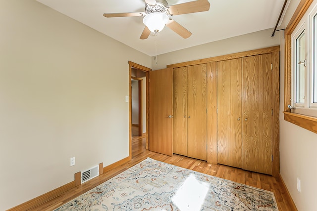 2441 Nottingham Rd, Ann Arbor, MI 48104 - unfurnished bedroom featuring light wood finished floors, a closet, ceiling fan, and baseboards