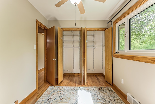 2441 Nottingham Rd, Ann Arbor, MI 48104 - unfurnished bedroom featuring light wood finished floors, multiple closets, a ceiling fan, and baseboards