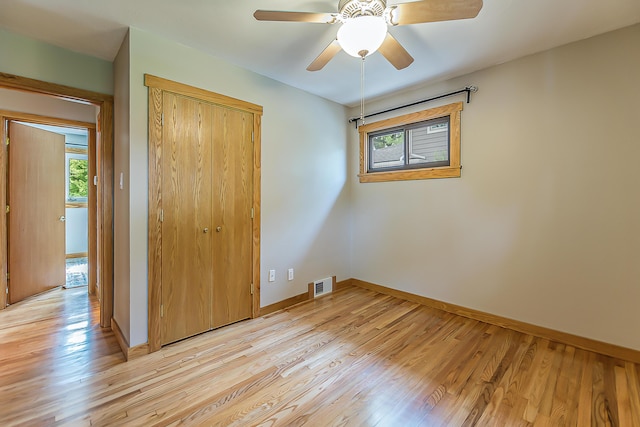 2441 Nottingham Rd, Ann Arbor, MI 48104 - unfurnished bedroom with a closet, baseboards, light wood-type flooring, and ceiling fan