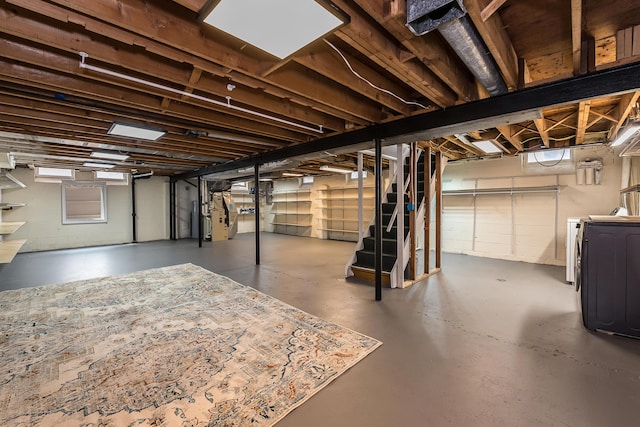 2441 Nottingham Rd, Ann Arbor, MI 48104 - basement featuring washing machine and clothes dryer, stairway, and heating unit