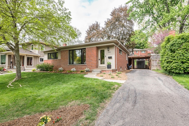 2441 Nottingham Rd, Ann Arbor, MI 48104 - tri-level home with a front lawn, a chimney, asphalt driveway, and brick siding