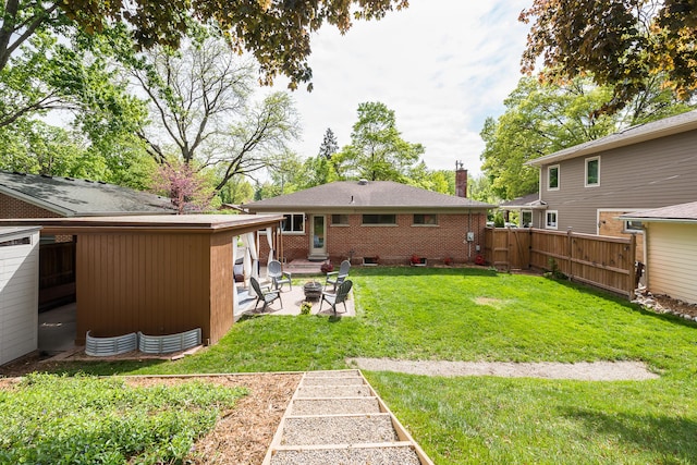 2441 Nottingham Rd, Ann Arbor, MI 48104 - view of yard with a patio and an outdoor fire pit