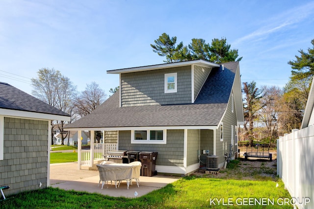 2245 Auburn Ave, Holland, MI 49424 - rear view of property featuring a shingled roof and a patio area