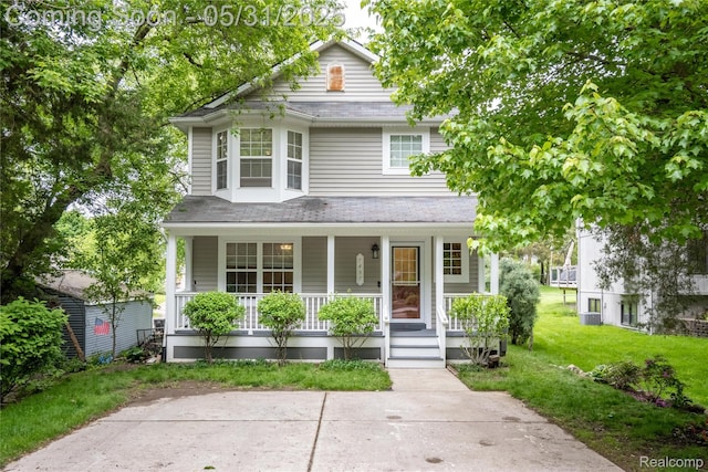 7457 Ore Lake Rd, Brighton, MI 48116 - view of front of property featuring a porch, a front yard, and central AC unit