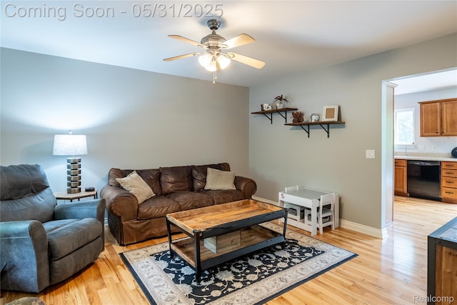7457 Ore Lake Rd, Brighton, MI 48116 - living room featuring light wood-type flooring, a ceiling fan, and baseboards