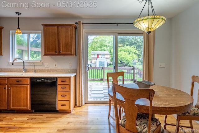 7457 Ore Lake Rd, Brighton, MI 48116 - kitchen with dishwasher, a sink, light countertops, and brown cabinets