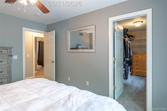 7457 Ore Lake Rd, Brighton, MI 48116 - carpeted bedroom with a walk in closet, a ceiling fan, and a closet