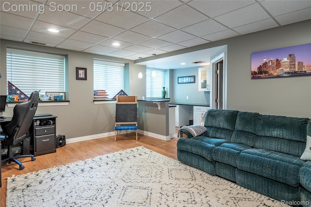 7457 Ore Lake Rd, Brighton, MI 48116 - home office with wood finished floors, a drop ceiling, and baseboards