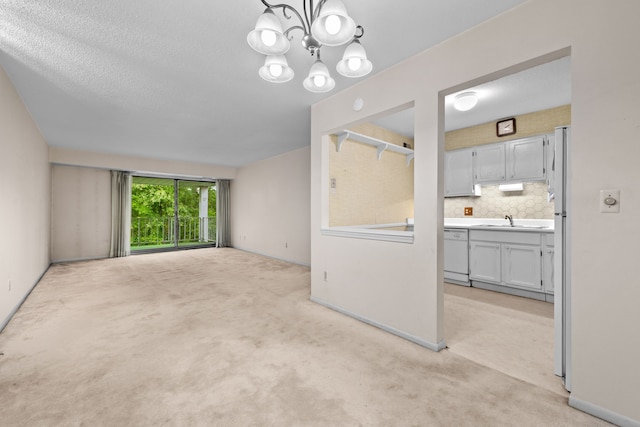 35980 Ann Arbor Trl, Livonia, MI 48150 - unfurnished living room featuring a sink, light colored carpet, and a chandelier