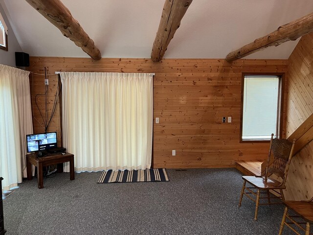 8711 M-37, Irons, MI 49644 - living area with wooden walls, beamed ceiling, and carpet floors