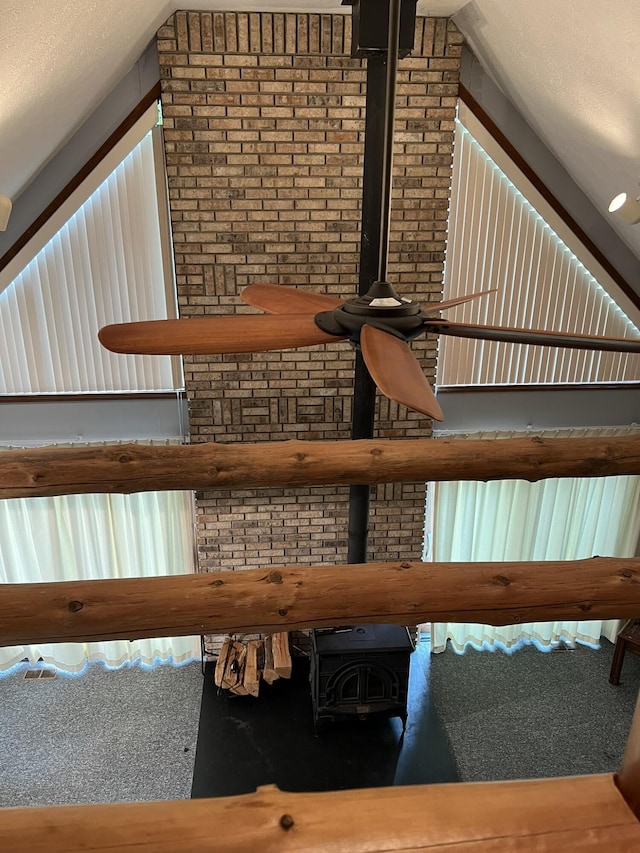 8711 M-37, Irons, MI 49644 - staircase featuring vaulted ceiling and a wood stove
