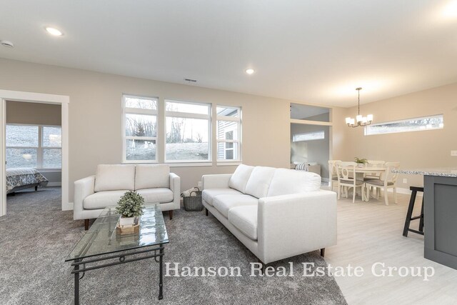 1422 Center Hill Rd SE Unit 46, Lowell, MI 49331 - living area with a chandelier, baseboards, recessed lighting, and light wood-style floors
