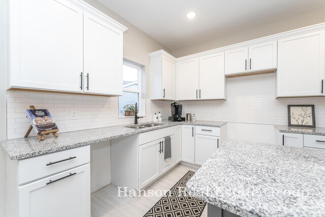 1422 Center Hill Rd SE Unit 46, Lowell, MI 49331 - kitchen with a sink, light stone counters, white cabinetry, backsplash, and recessed lighting