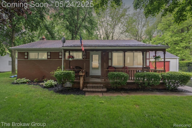 6605 Northview Dr, Clarkston, MI 48346 - view of front of home featuring covered porch, a front lawn, brick siding, and a chimney