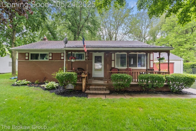 6605 Northview Dr, Clarkston, MI 48346 - view of front of property featuring a porch, a front yard, brick siding, and a shingled roof