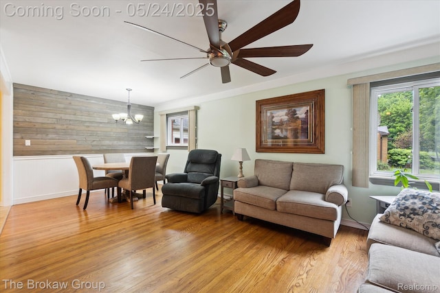 6605 Northview Dr, Clarkston, MI 48346 - living area with wooden walls, ceiling fan, a chandelier, light wood-style floors, and baseboards