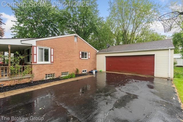 6605 Northview Dr, Clarkston, MI 48346 - view of property exterior featuring an outbuilding, driveway, and brick siding