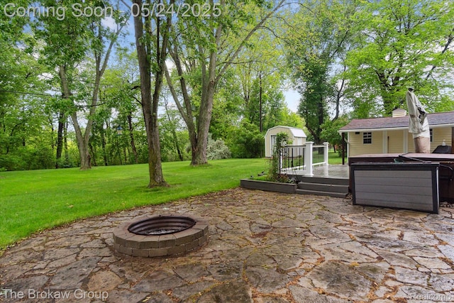 6605 Northview Dr, Clarkston, MI 48346 - view of patio / terrace with a fire pit, a wooden deck, and view of scattered trees