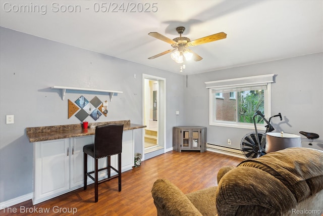 6605 Northview Dr, Clarkston, MI 48346 - living area featuring wood finished floors, a baseboard radiator, ceiling fan, and baseboards