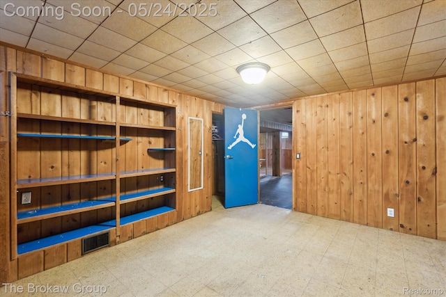 6605 Northview Dr, Clarkston, MI 48346 - unfurnished room with tile patterned floors and wood walls