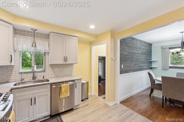 6605 Northview Dr, Clarkston, MI 48346 - kitchen featuring stainless steel dishwasher, a sink, stove, decorative backsplash, and light wood-style floors