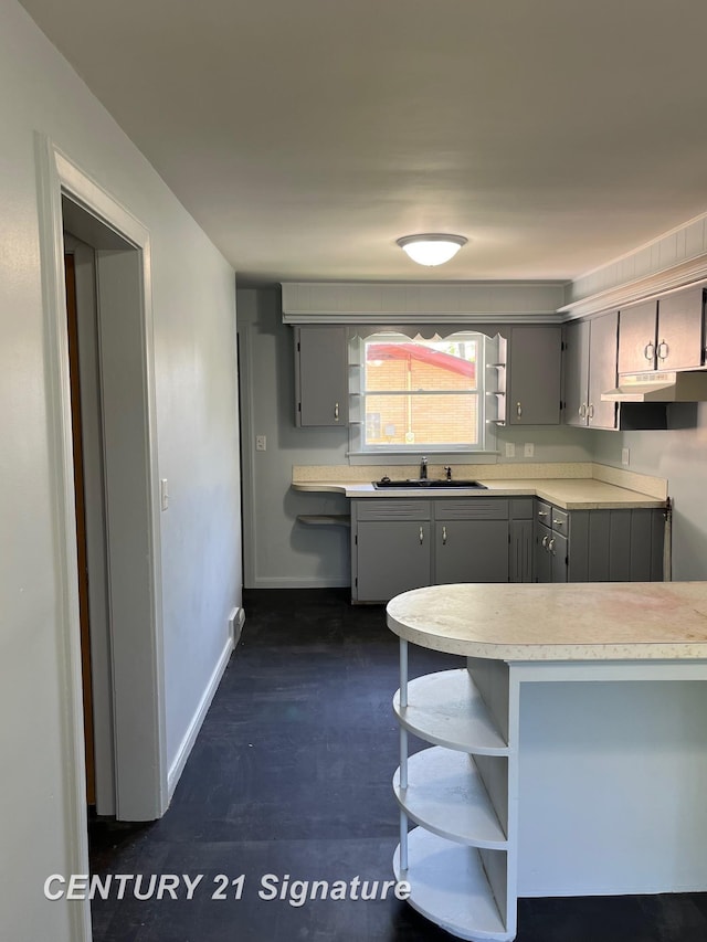 2222 Stone St, Saginaw, MI 48602 - kitchen featuring open shelves, gray cabinets, a sink, light countertops, and baseboards