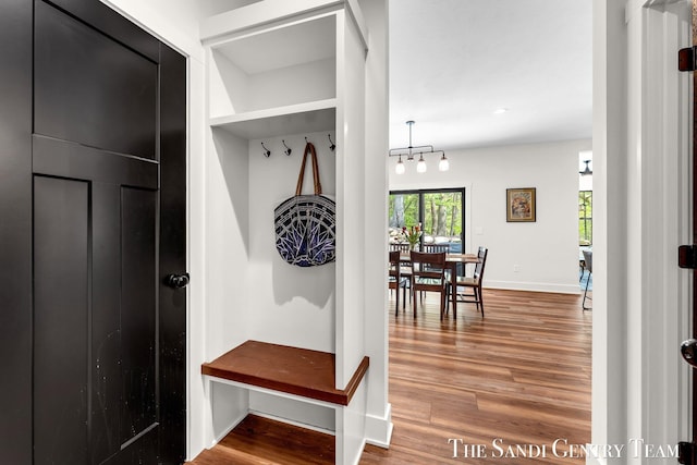 mudroom featuring wood finished floors and baseboards