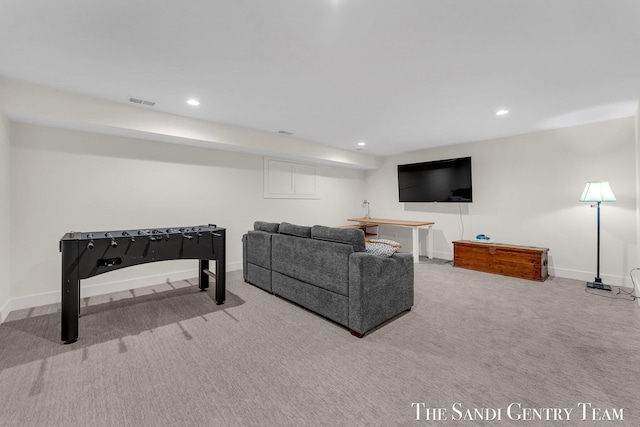carpeted living room featuring baseboards and recessed lighting