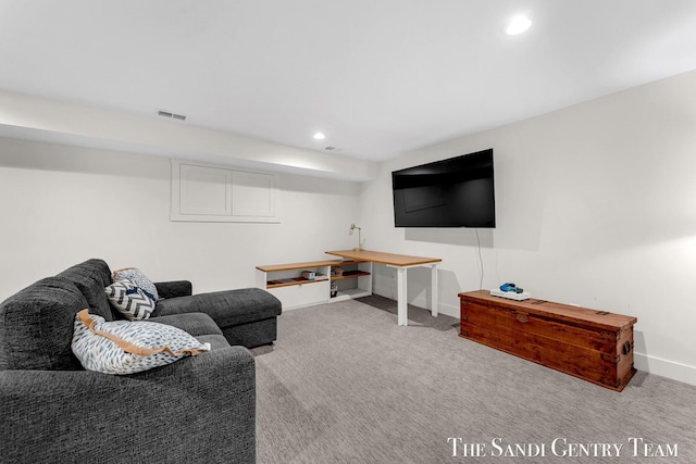 carpeted living area with baseboards and recessed lighting