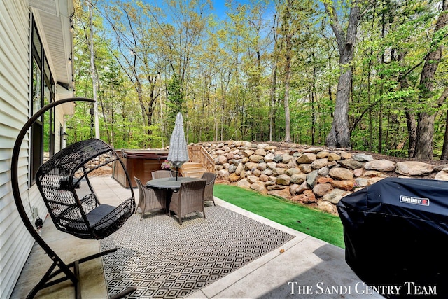 view of patio featuring a hot tub, outdoor dining space, and area for grilling