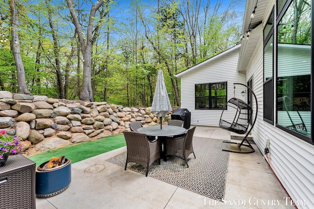 view of patio / terrace with an outdoor fire pit and outdoor dining area