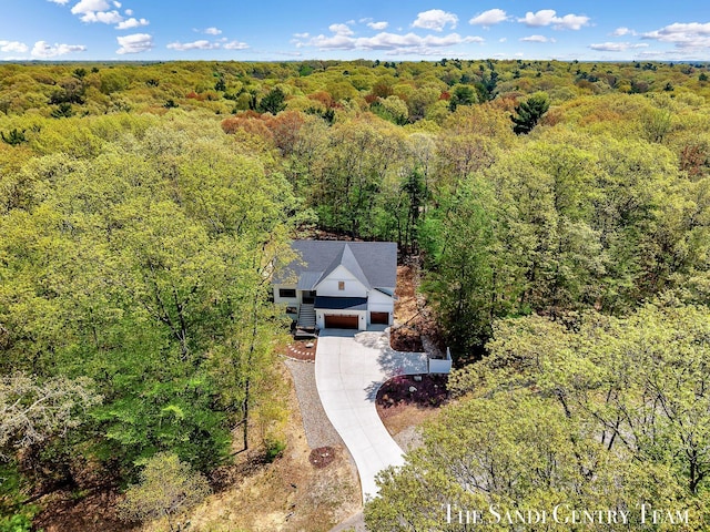 view of subject property with a heavily wooded area