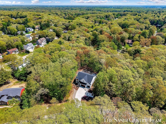 aerial view of residential area with a heavily wooded area