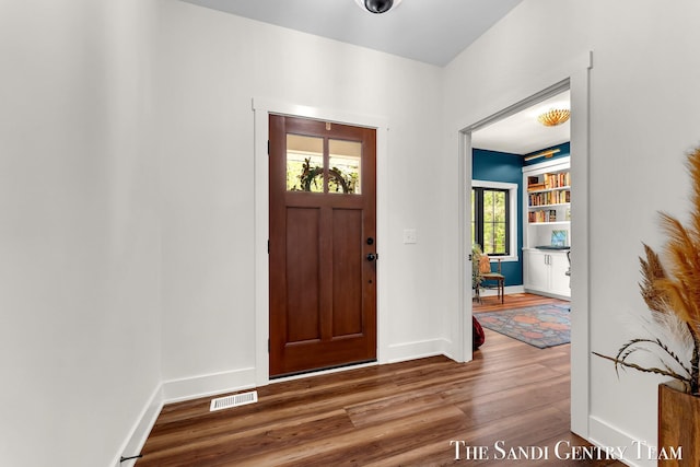 entryway featuring wood finished floors and baseboards