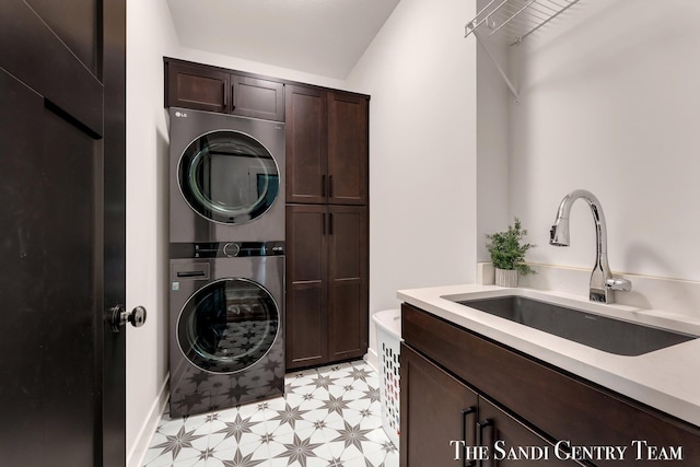 laundry room with stacked washer and clothes dryer, cabinet space, and light flooring