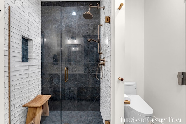 bathroom with a stall shower and toilet