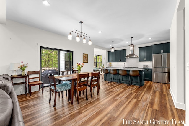 dining area with light wood-type flooring and recessed lighting